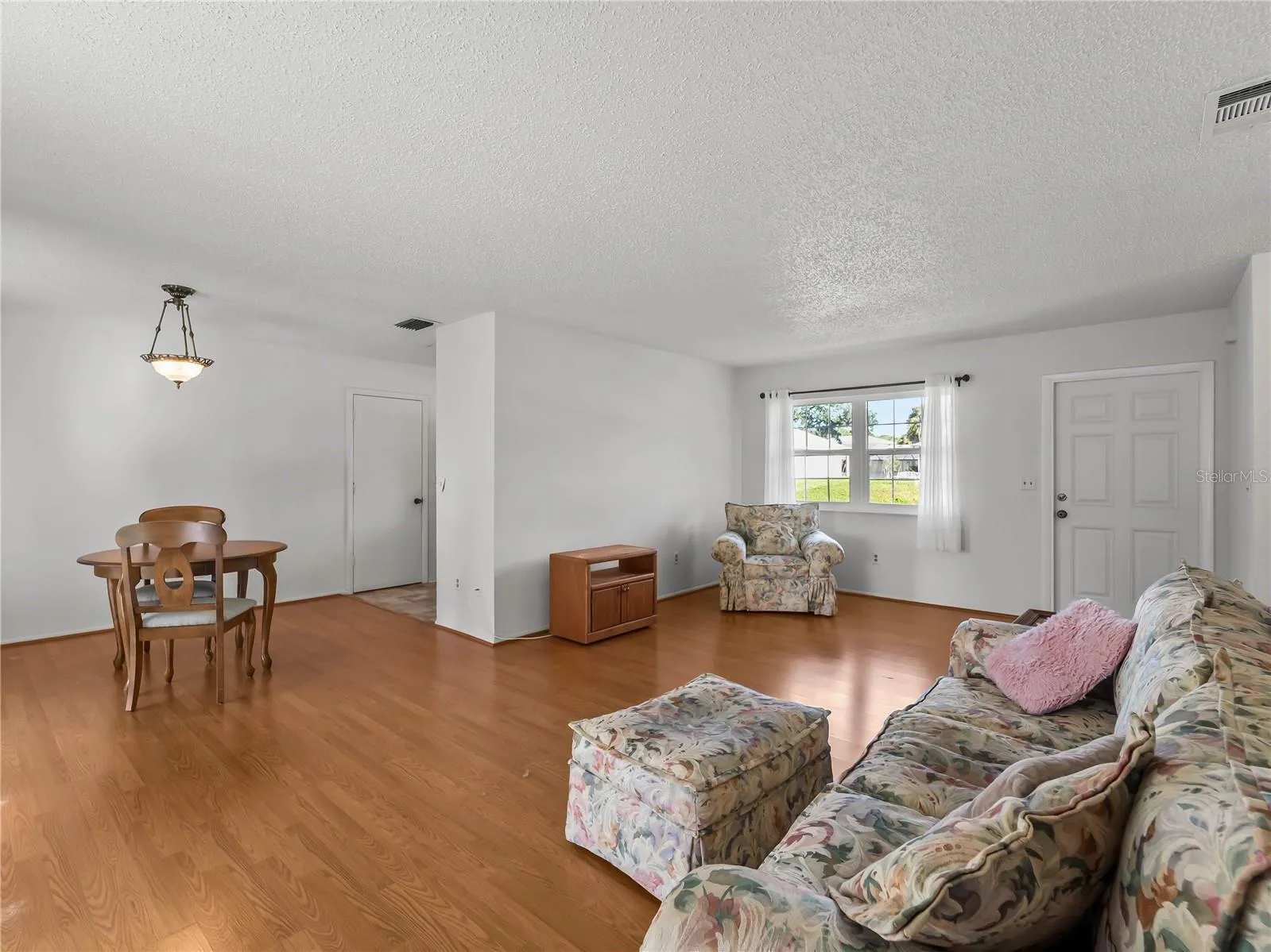 DiningLiving_18103WindsweptAvenue_PortCharlotte_OpenConcept_Corner.jpg