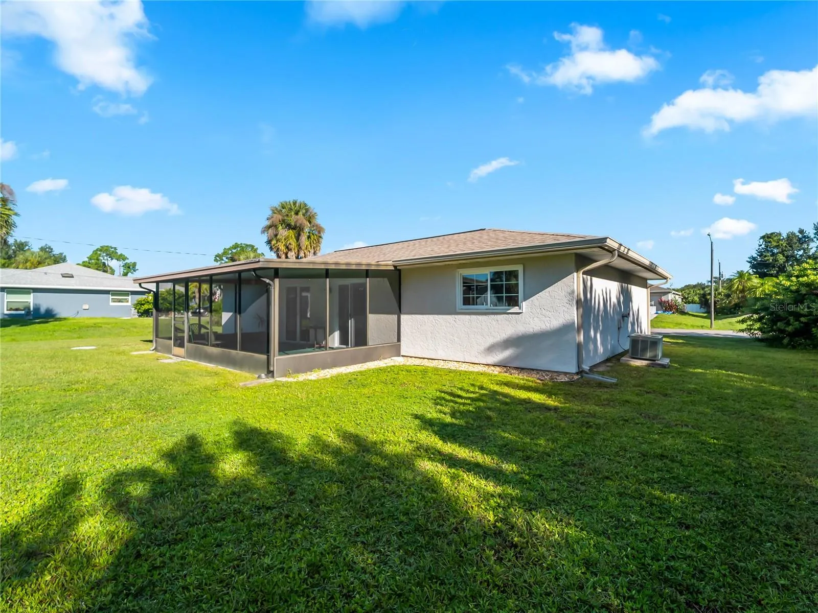 RearExterior_18103WindsweptAvenue_PortCharlotte_SpaciousLawn_Daylight.jpg