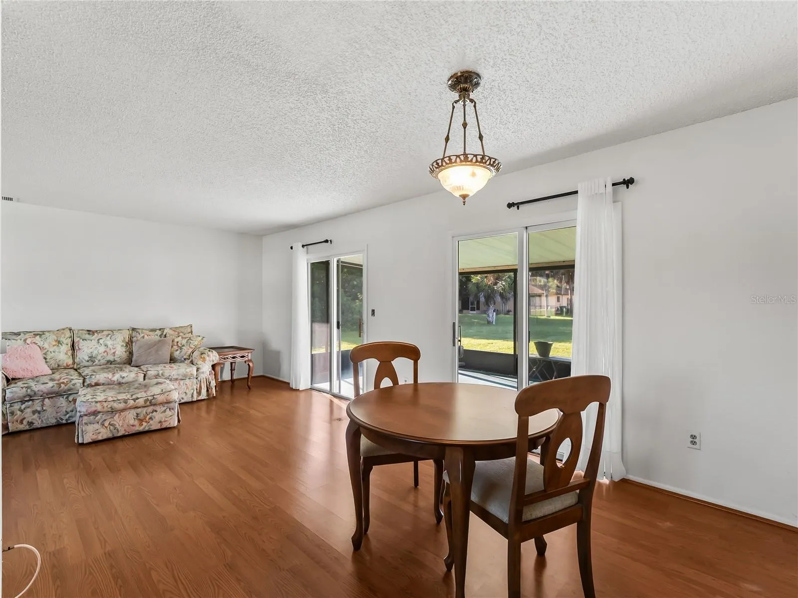 DiningLiving_18103WindsweptAvenue_PortCharlotte_OpenConcept_WindowView.jpg