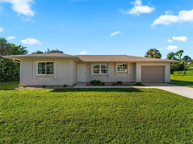 FrontExterior_18103WindsweptAvenue_PortCharlotte_SpaciousLawn_Daylight.jpg