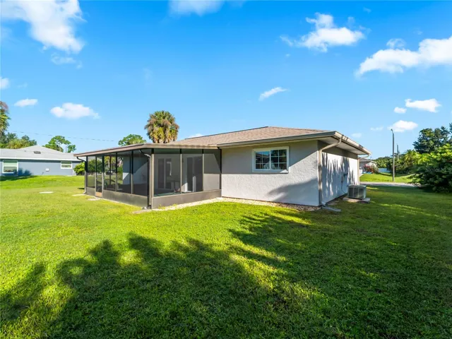 RearExterior_18103WindsweptAvenue_PortCharlotte_SpaciousLawn_Daylight.jpg