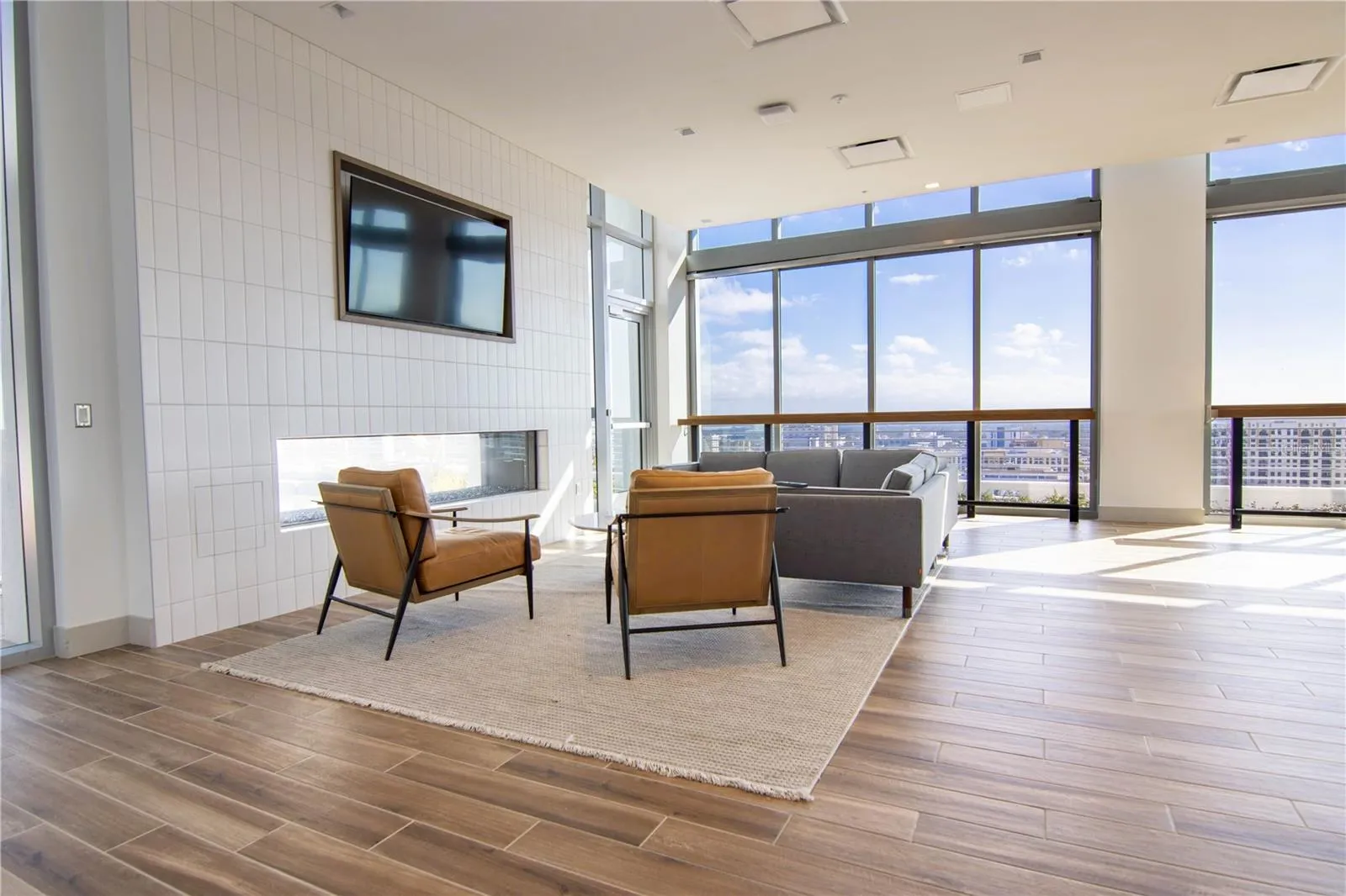 Beautiful community room with see through fireplace, tv, 3 walls of sliding glass doors, prep kitchen and more