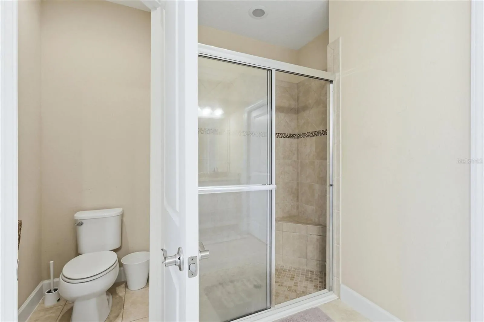Pirmary en-suite walk-in glass enclosed shower