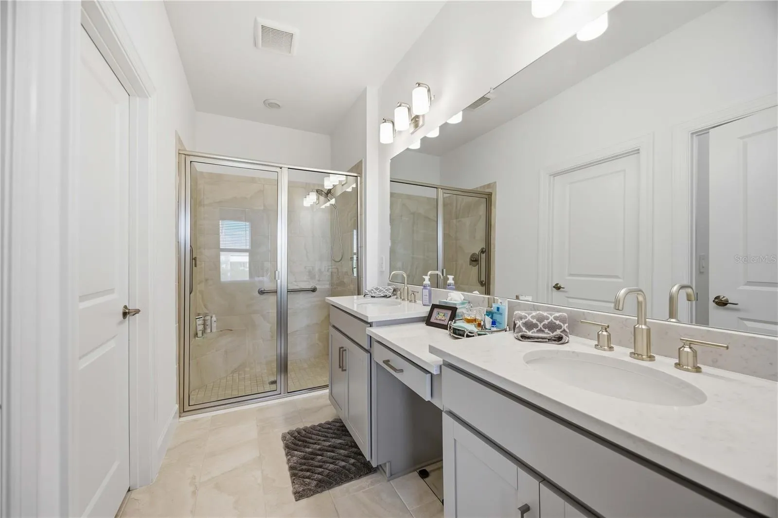 En suite bath with walk in shower, 2 sinks and vanity, Walk in closet and water closet