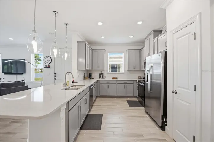 Kitchen features quartz counters, washer, dryer, fridge with ice maker, stove, microwave with vent!) double sink had garbage disposal.