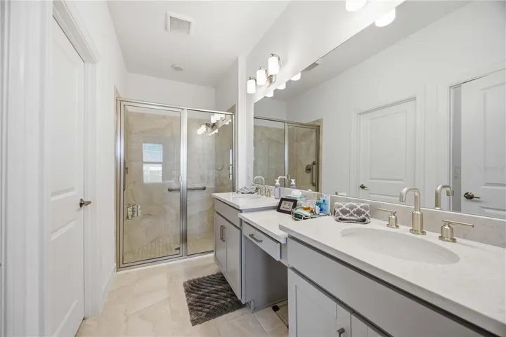 En suite bath with walk in shower, 2 sinks and vanity, Walk in closet and water closet
