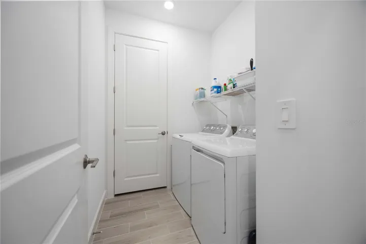 Laundry room with AC in closet