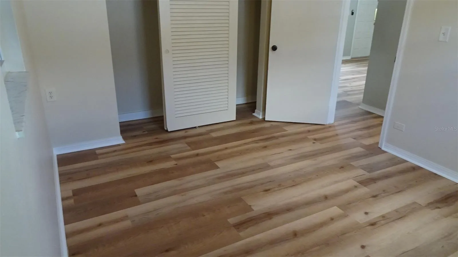 Nice floors! Primary bedroom, wooded closet doors, not the old metal.