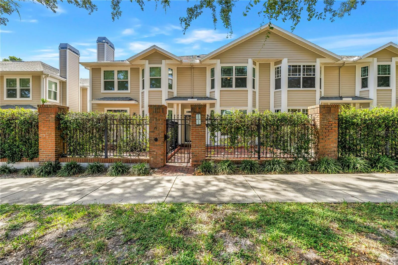 Front exterior of this beautifully updated residence with a private gated brick courtyard and 2-car garage.