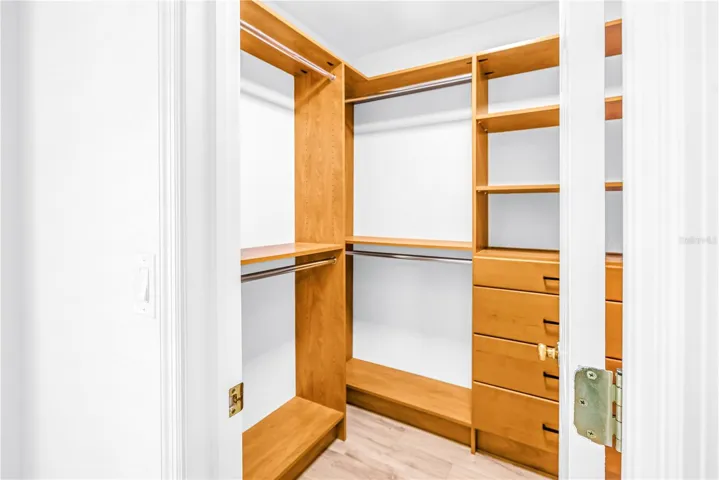 Primary Bedroom walk-in closet with California Closet