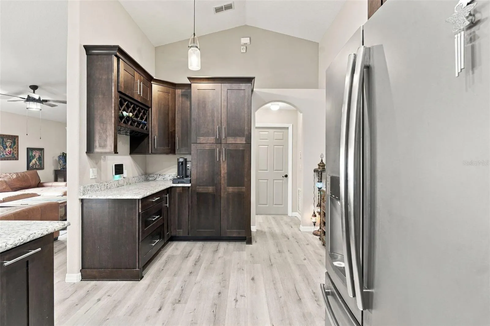 Kitchen towards wine rack, pantry, and laundry room/garage.