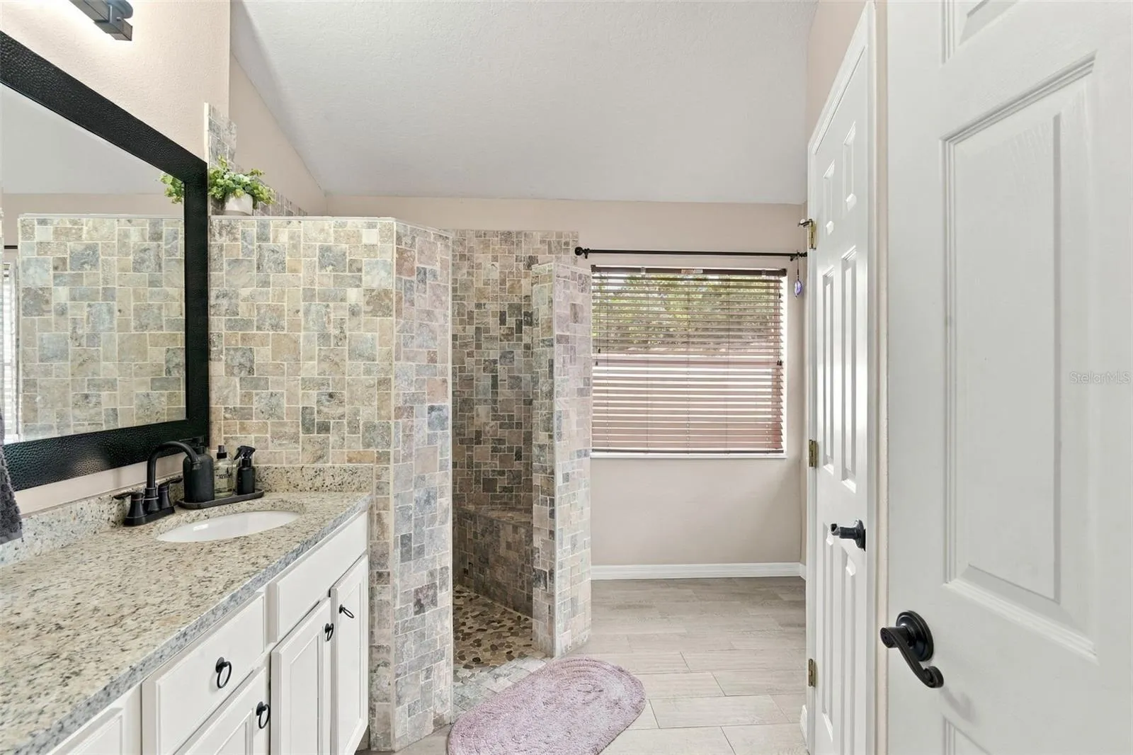 Ensuite bath with water closet at right.