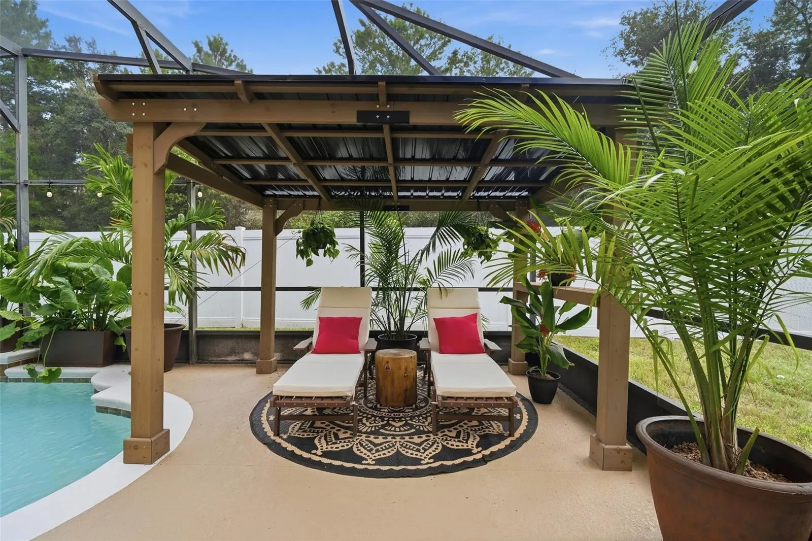 Shaded sitting area next to the swimming pool.