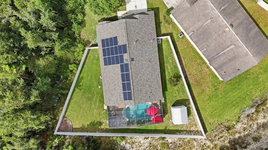 Overhead view of home and fenced back yard. Yes...those panels are paid off!