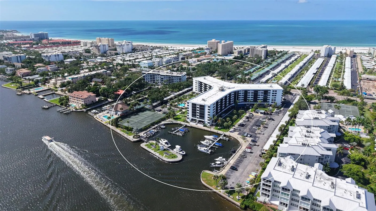 Aerial of back of building showing marina and waterway as well as Gulf