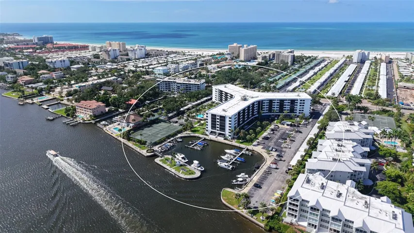 Aerial of back of building showing marina and waterway as well as Gulf