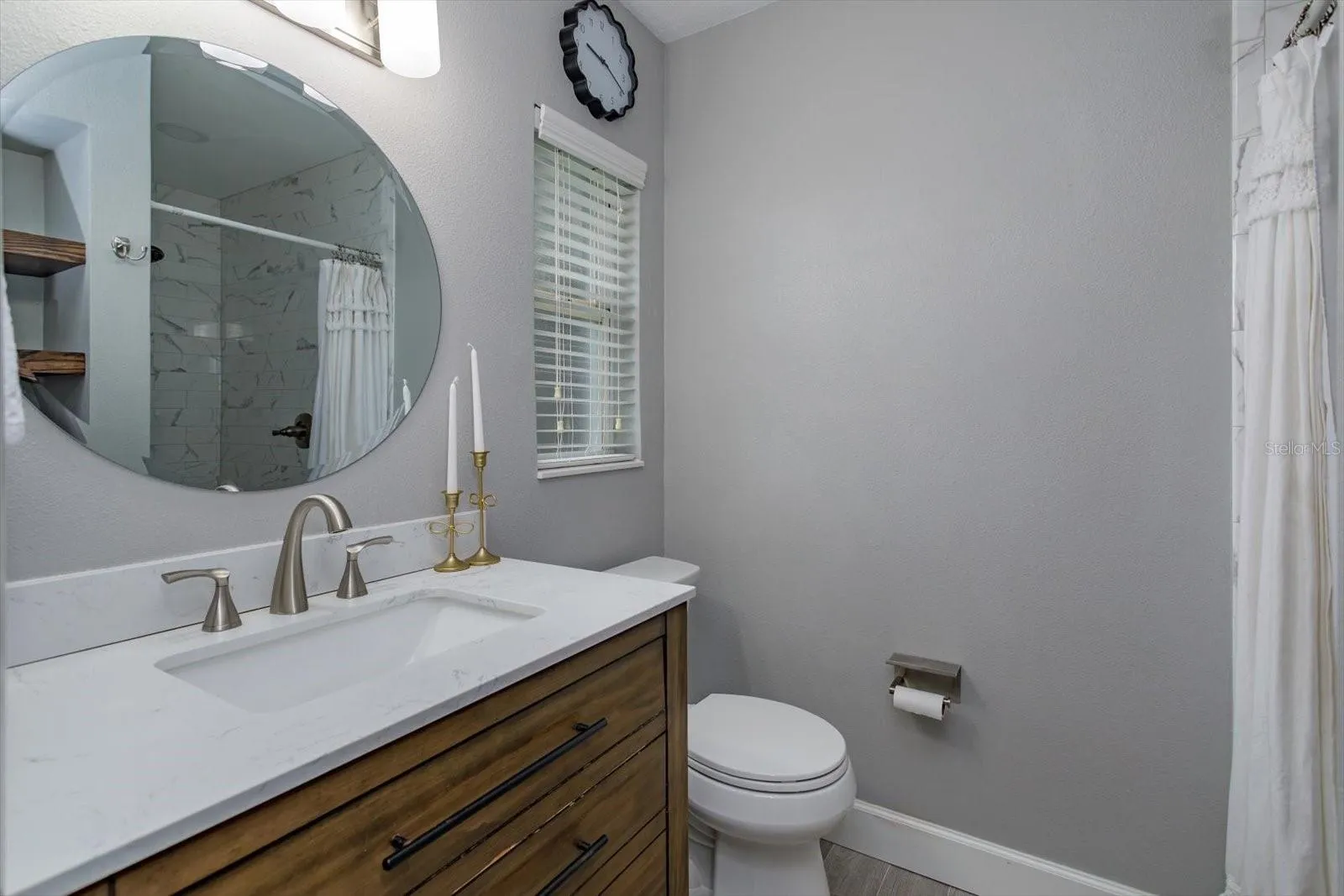 Primary ensuite with updated quartz-topped vanity and shower