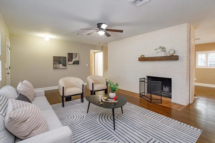15 x 13 living room with original brick accent wall and double sided wood burning fireplace