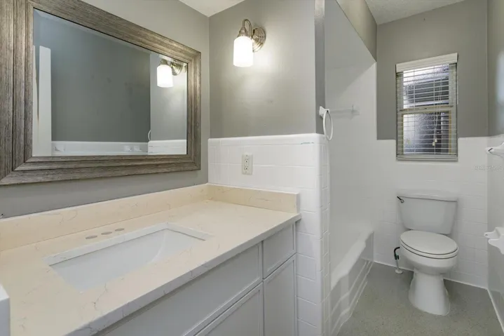 Hall bath with updated vanity and tub/shower