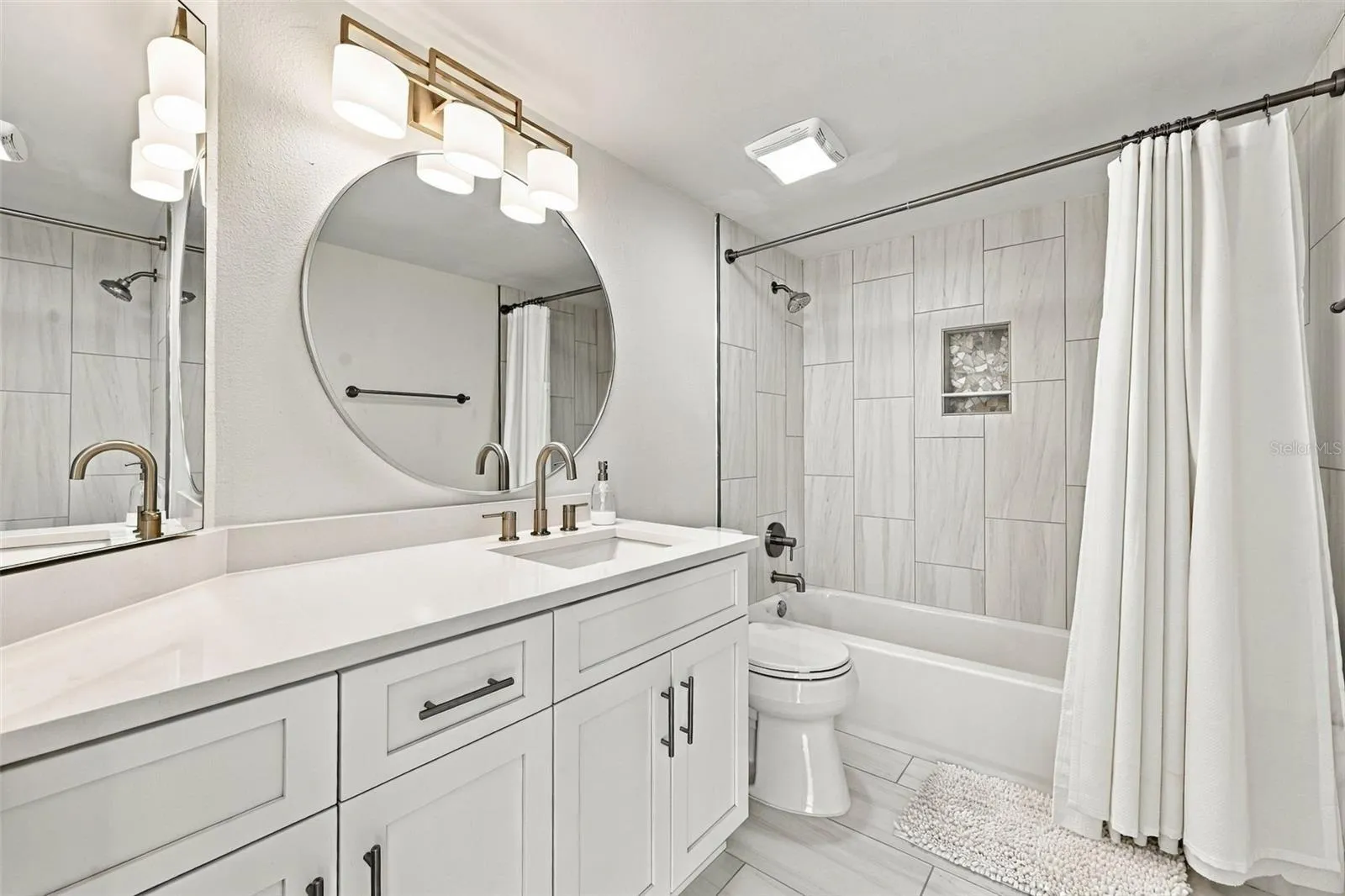 The third bath serves as a hall bath for guests and is just outside the third bedroom for convenience.