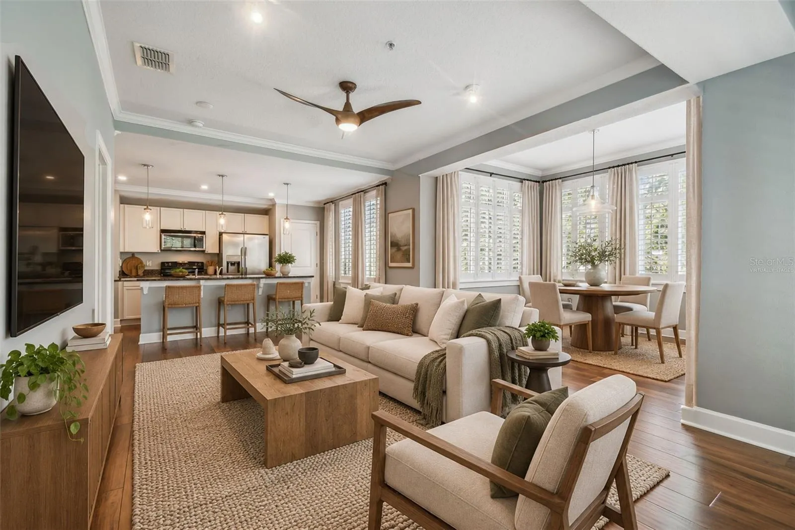 Virtually staged photos of living/dining combo with an abundance of natural light.