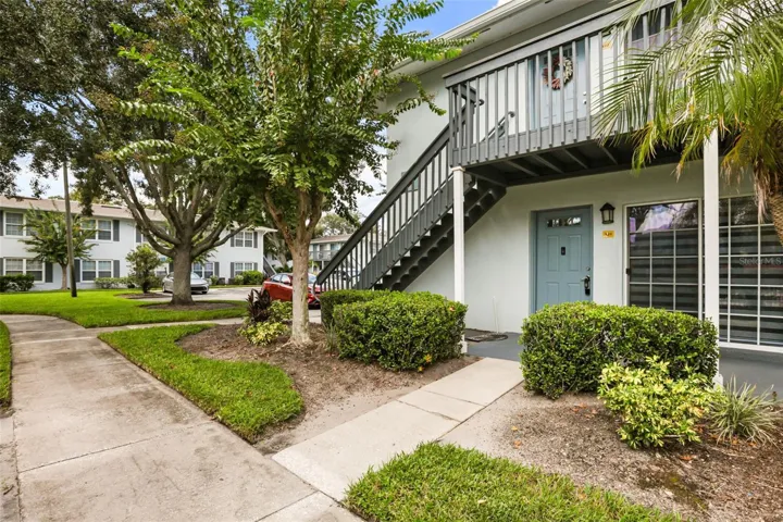 Ground-floor corner condo at Sienna Place, surrounded by mature landscaping and just steps from the community pool.