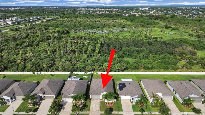 Aerial of home with tree farm in back