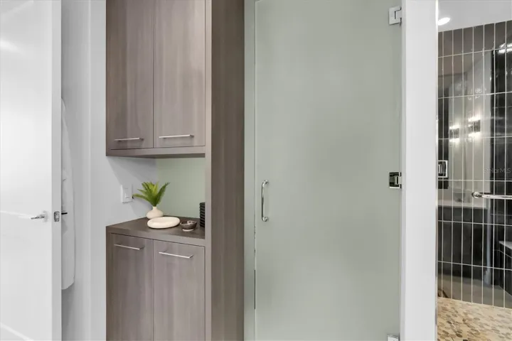 Private water closet inside primary bath custom linen closet.