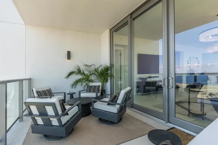 Covered high-rise terrace with lounge area.