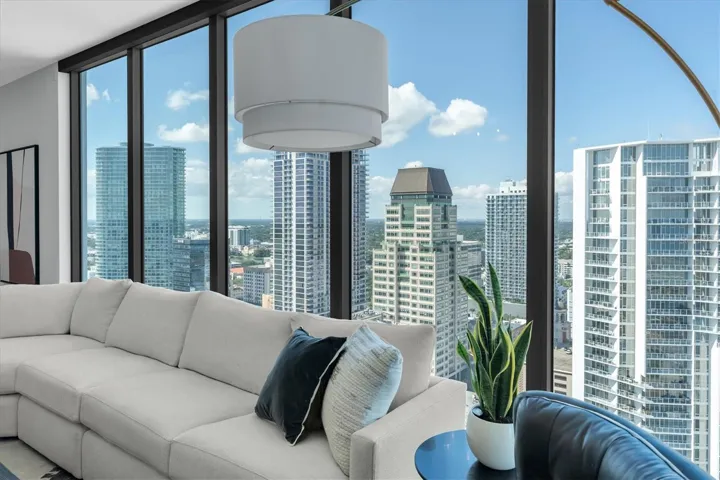 Spacious glass living area with open flow.