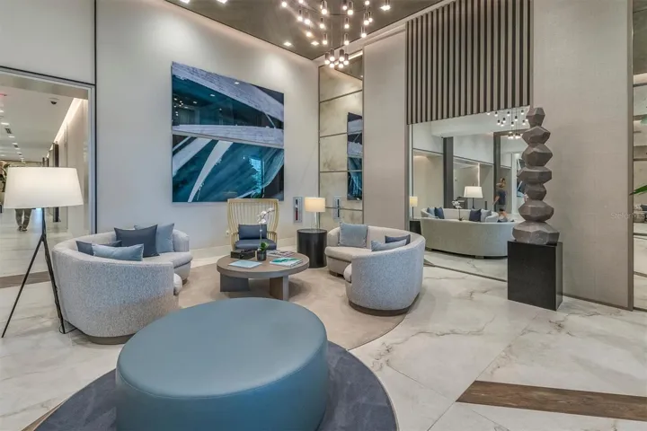 Grand double-height lobby with concierge desk.
