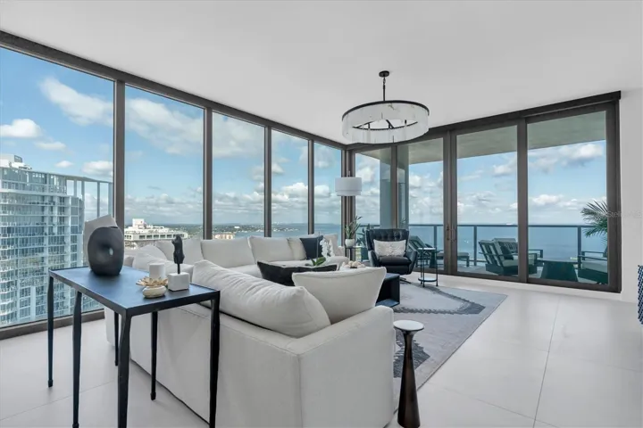 Expansive glass walls frame downtown city/bay views from great room