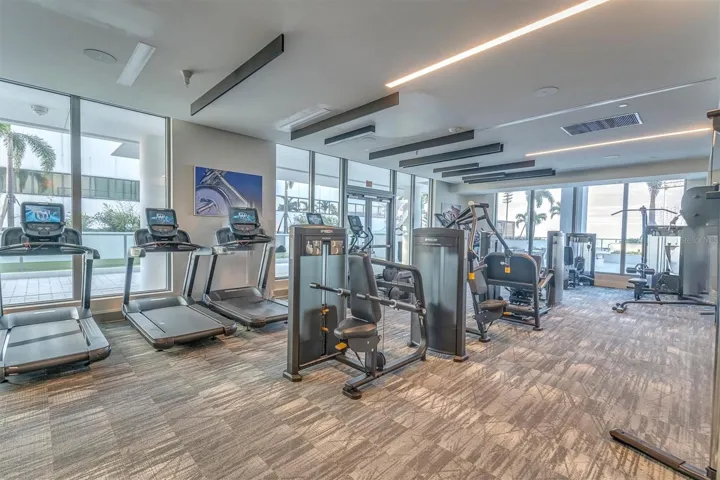State-of-the-art fitness center with glass walls and separate mat workout area.