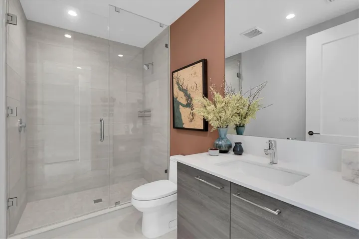 Guest ensuite bath with glass shower.