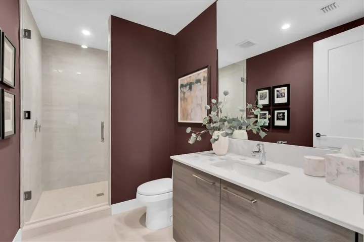 Stylish full guest bath with glass shower.