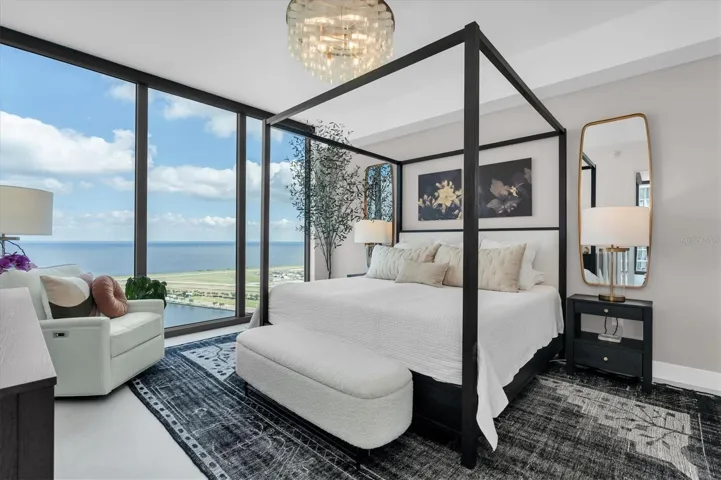 Primary suite with floor-to-ceiling glass walls.