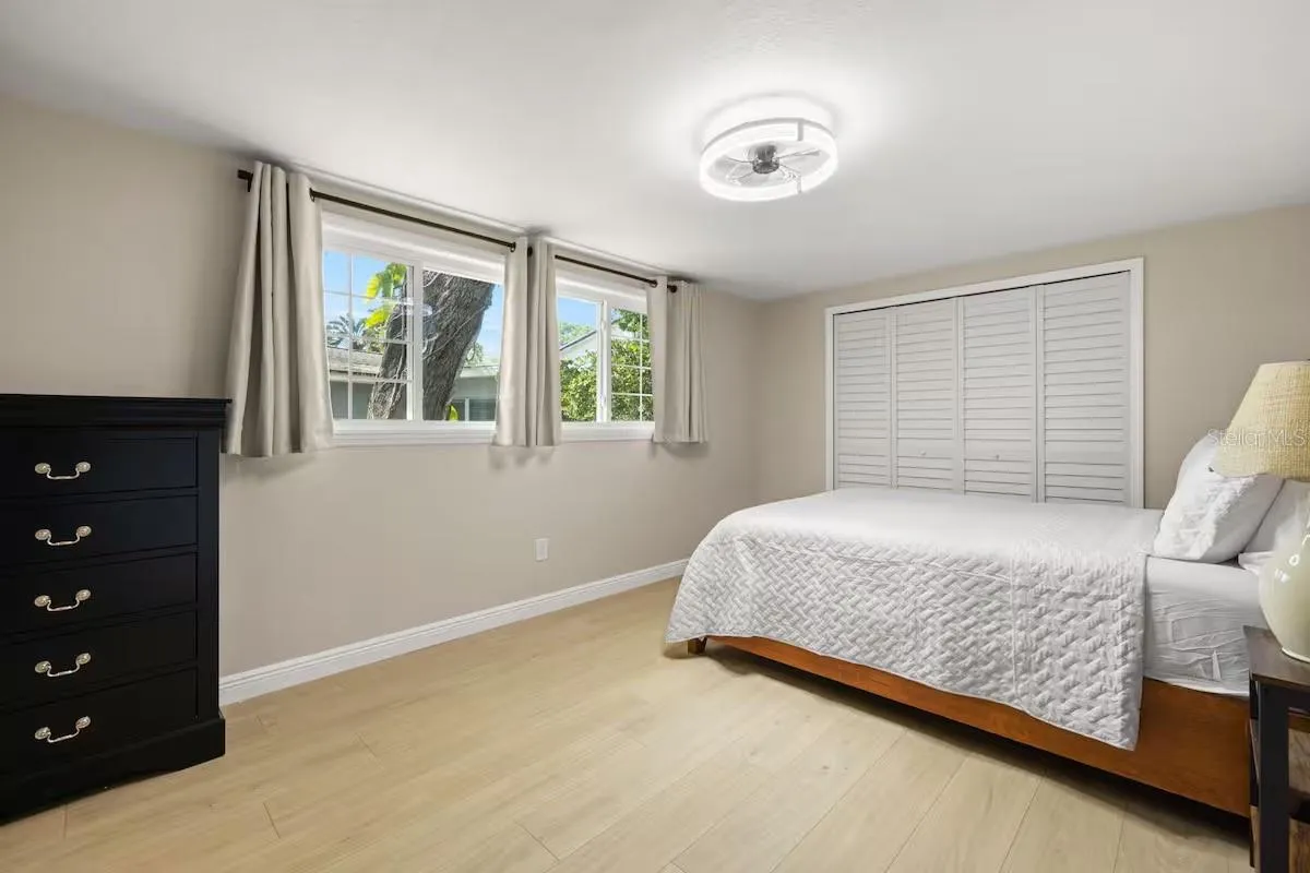 Another angle highlights the room’s TWO WINDOWS, large closet, and generous floor space.