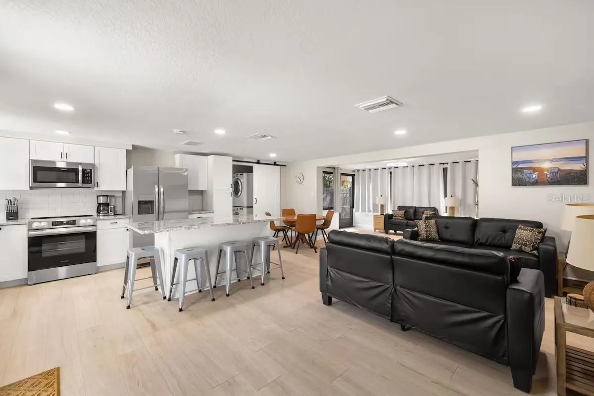 This wide-angle view really shows off the OPEN FLOOR PLAN, connecting the kitchen, dining, and multiple living spaces for easy everyday living and entertaining.