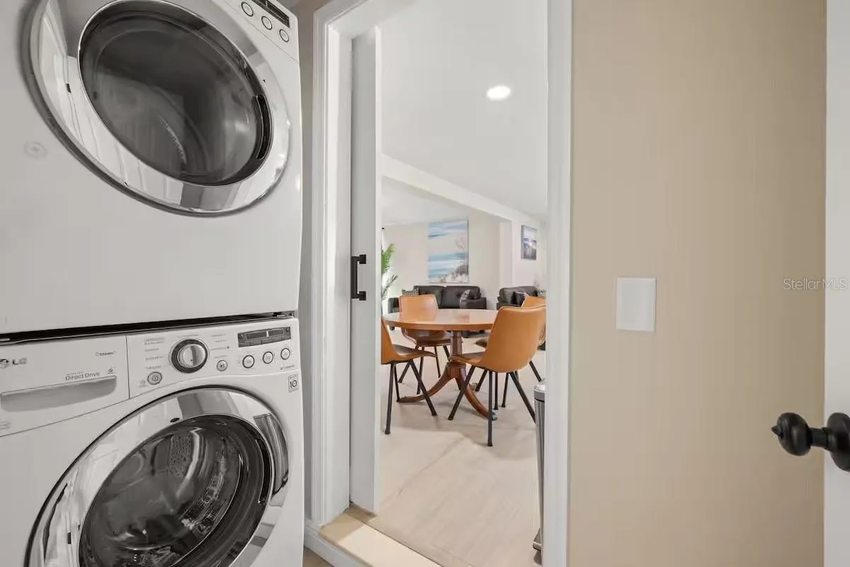 Convenient in-home laundry with a full-size stacked washer and dryer, neatly tucked away while remaining easily accessible from the main living area.