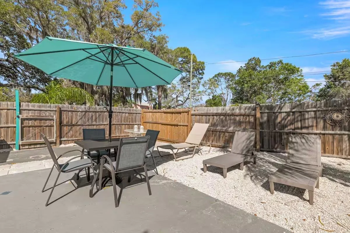 Multiple outdoor living areas provide space for dining in the shade, lounging poolside, or simply kicking back after a swim.