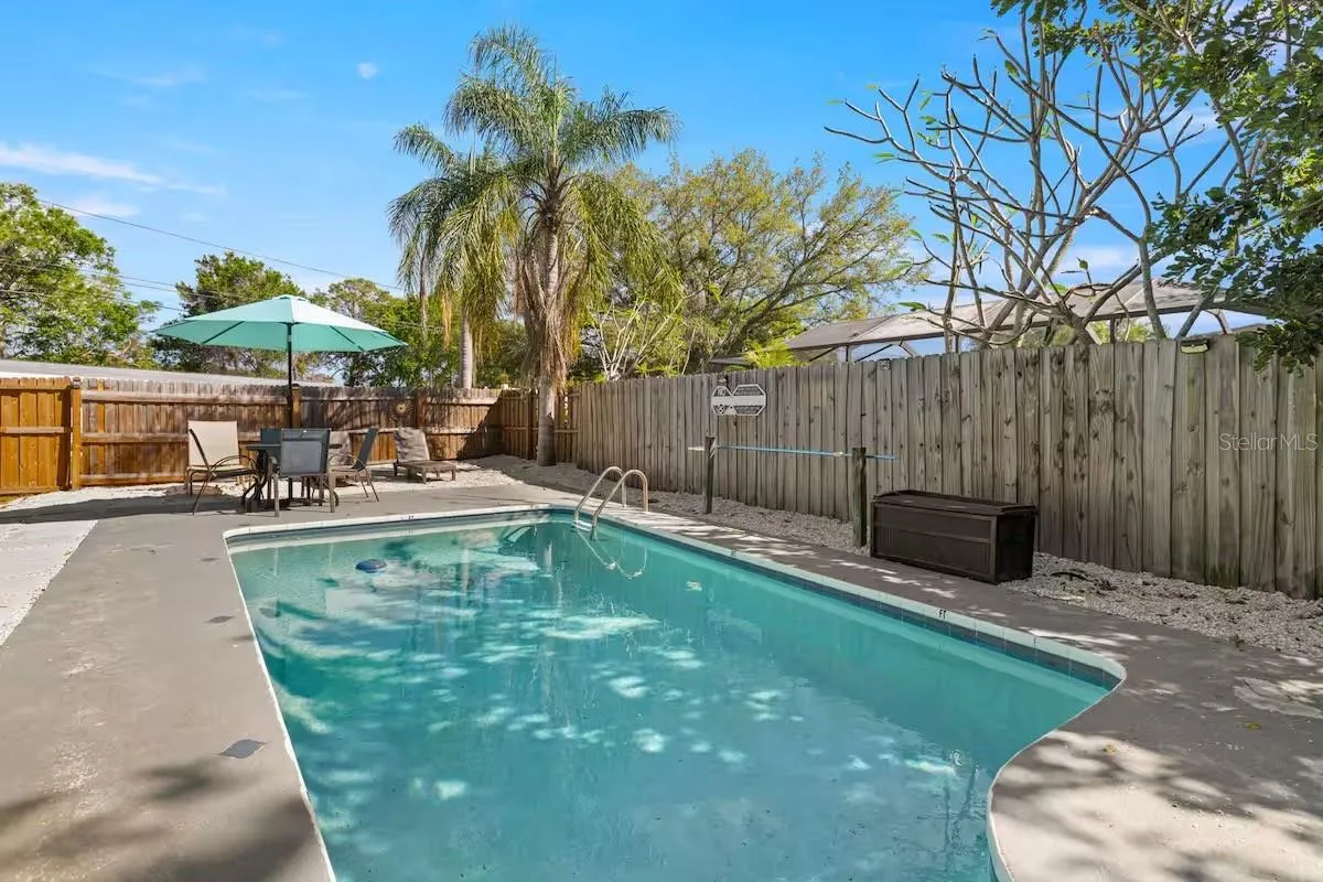 Sparkling in-ground pool surrounded by a spacious deck and privacy fencing—your own backyard escape for sunny Florida days.