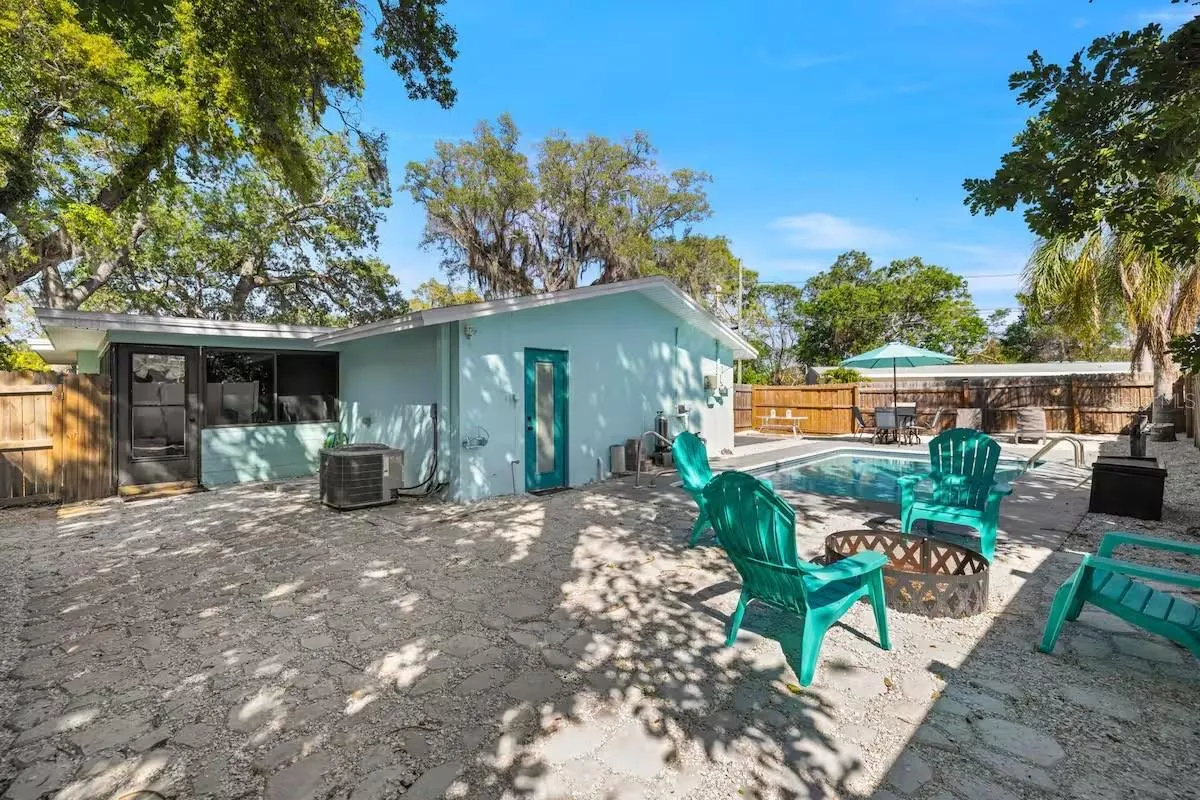 A fully fenced backyard offers more than just a pool, with a dedicated fire-pit area and plenty of space to gather outdoors.