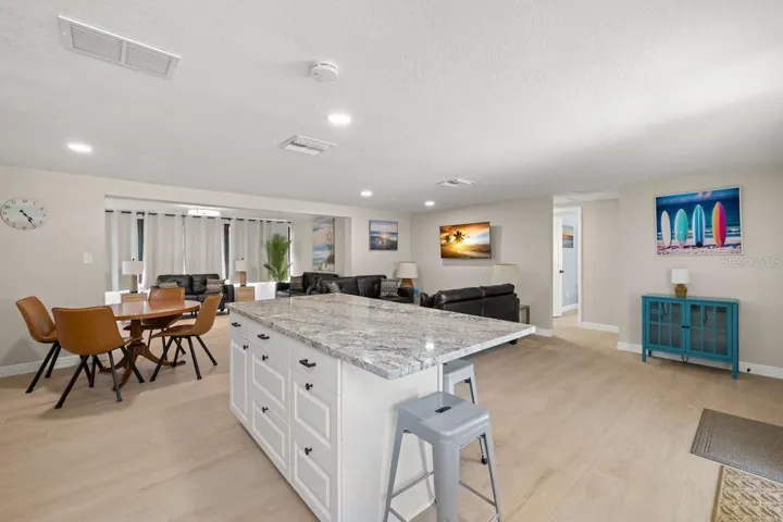 The LARGE GRANITE ISLAND provides loads of prep space, additional storage, and casual seating—the natural gathering spot of the home.