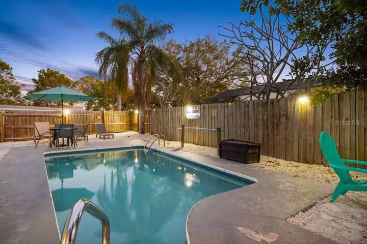 The private HEATED POOL takes center stage in this fully fenced backyard, with plenty of room to relax, dine, and enjoy Florida evenings outdoors.