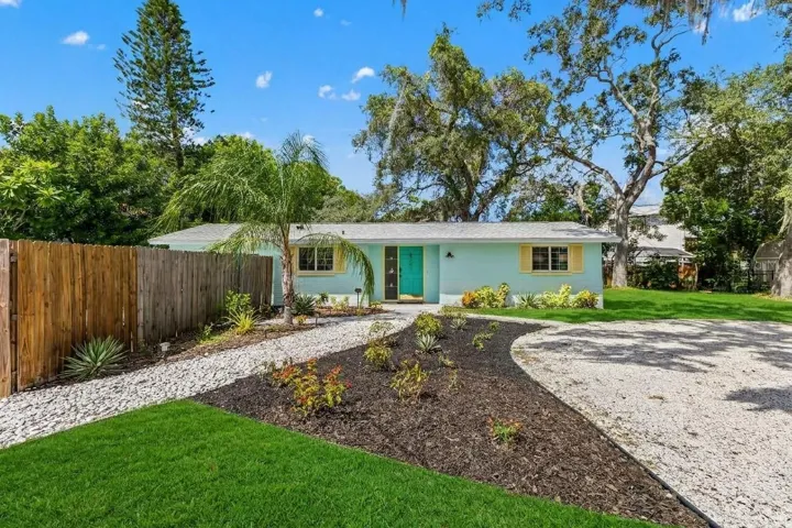 Welcome home to OZONA! A NEW ROOF (2024), cheerful coastal exterior, expansive driveway, and gated access to the fully fenced pool area set the stage for the laid-back Florida lifestyle.
