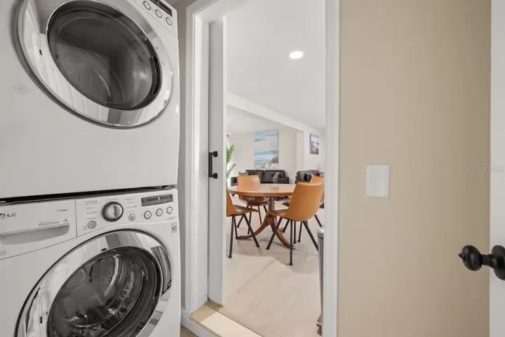 Convenient in-home laundry with a full-size stacked washer and dryer, neatly tucked away while remaining easily accessible from the main living area.