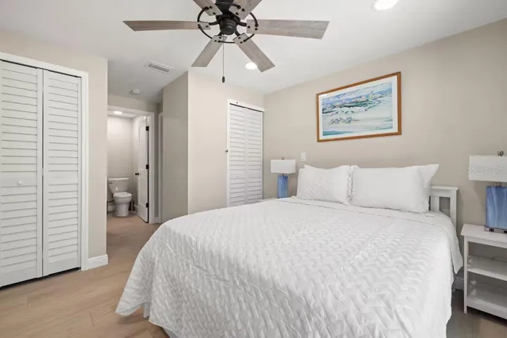 Another view of the primary suite highlights TWO CLOSETS and convenient access to the ensuite bath.