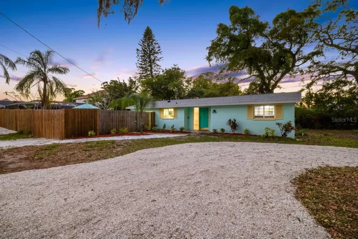 Welcome home to OZONA! A NEW ROOF (2024), cheerful coastal exterior, expansive driveway, and gated access to the fully fenced pool area set the stage for the laid-back Florida lifestyle.
