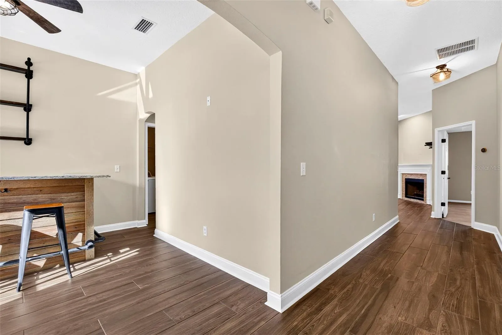 View from front door. Hallway straight ahead and dining room/bar to the left.