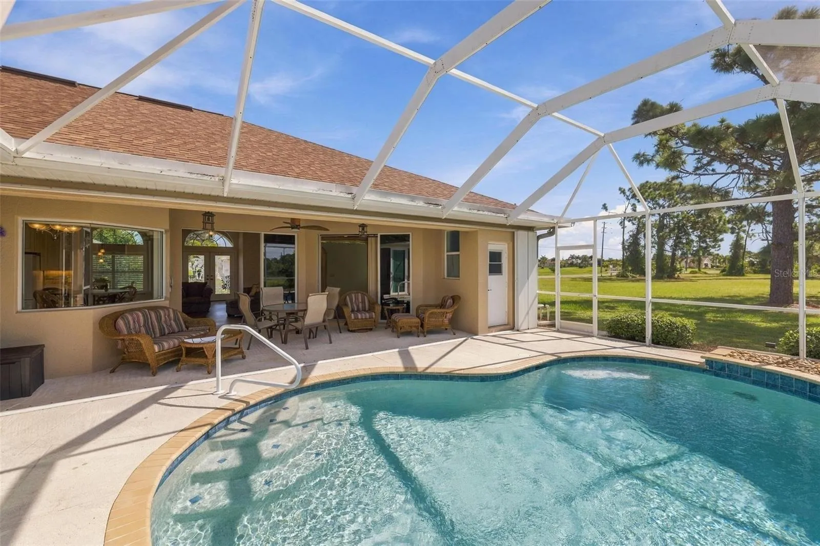 Across the pool is the covered area of your lanai and to the right is the pool bath...